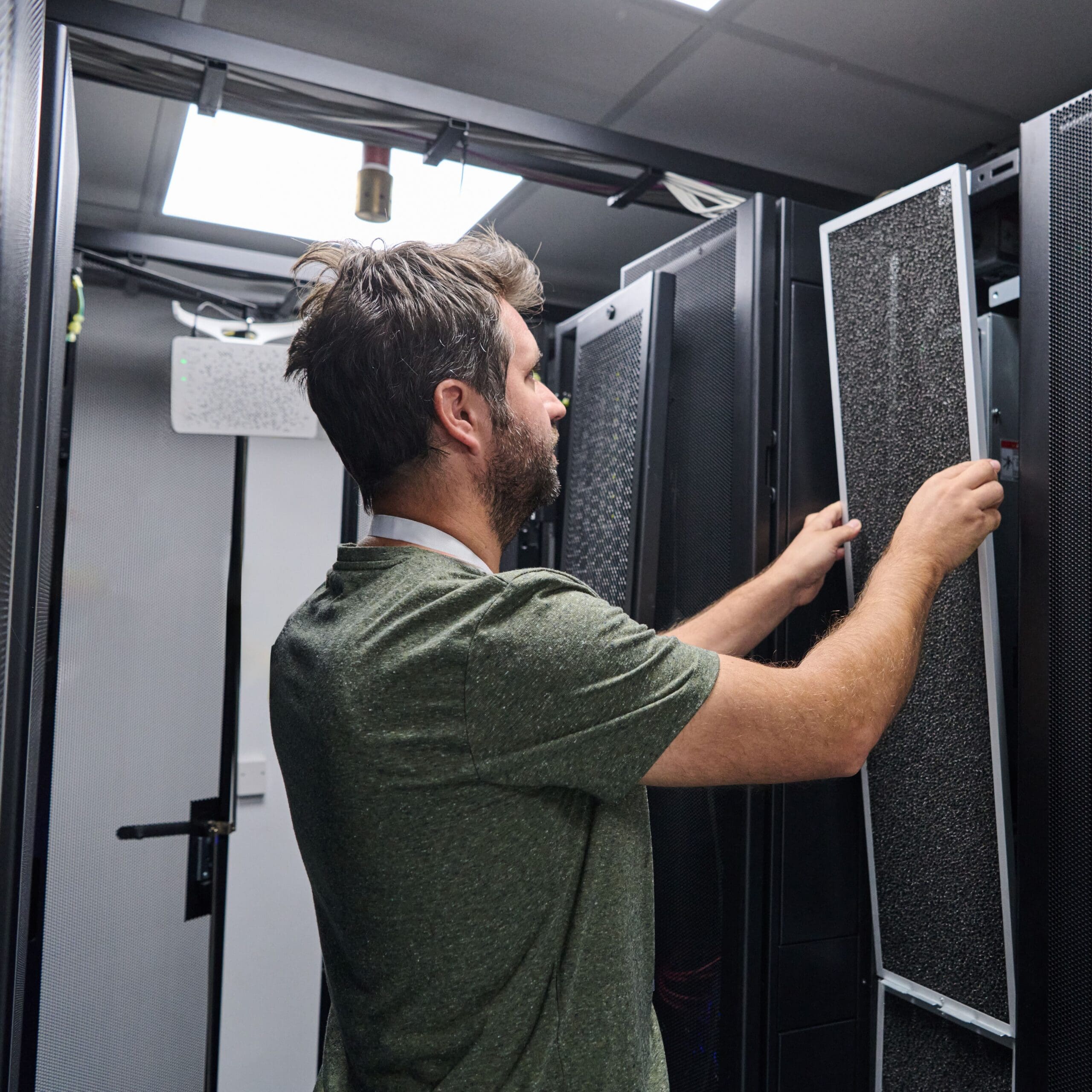 Data center technician replaces air filter