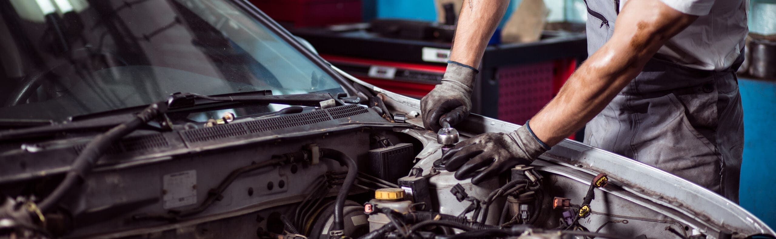 car mechanic fixing automotive engine